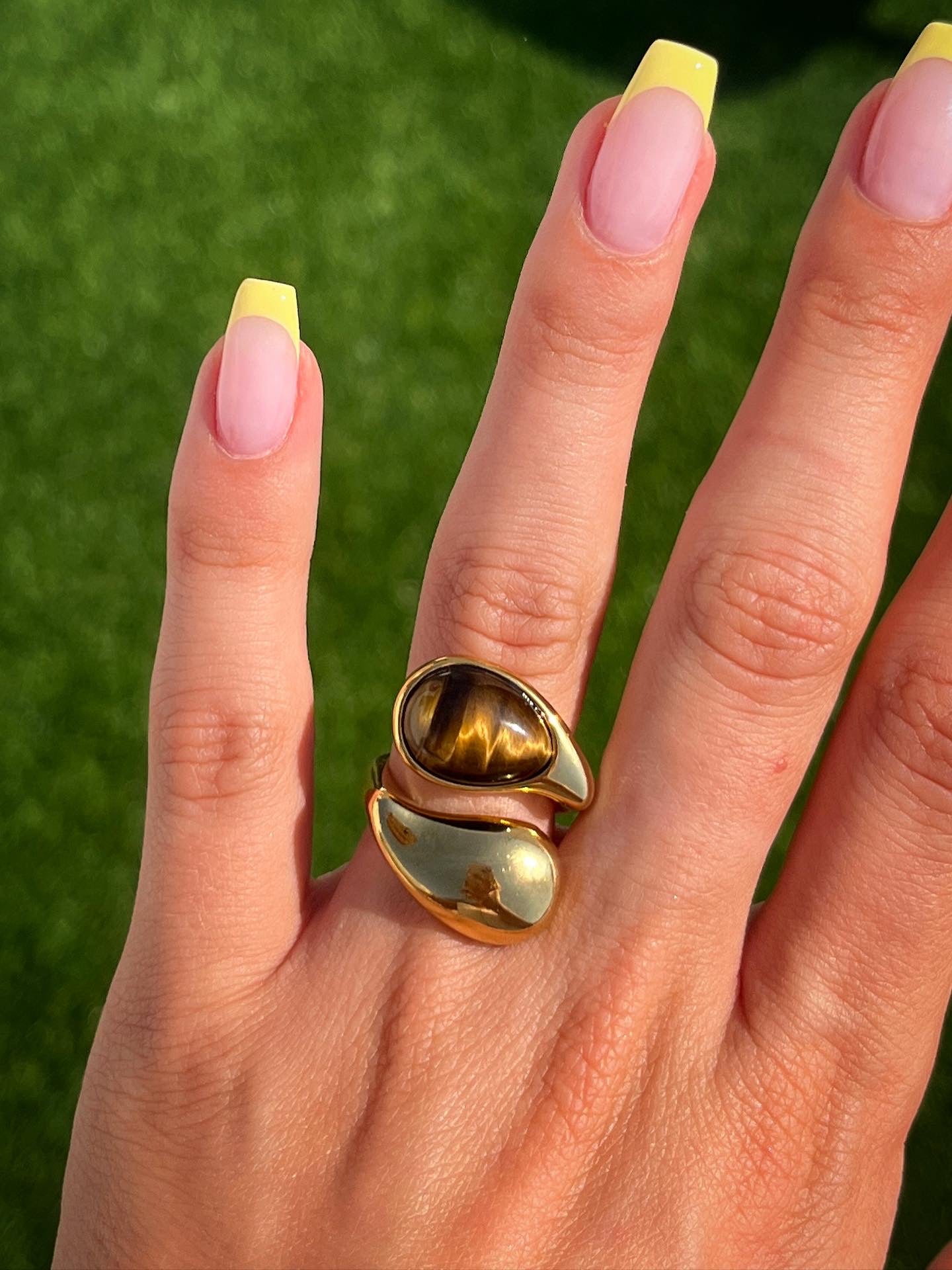 Model wearing Sienna gold ring on hand with stacked rings