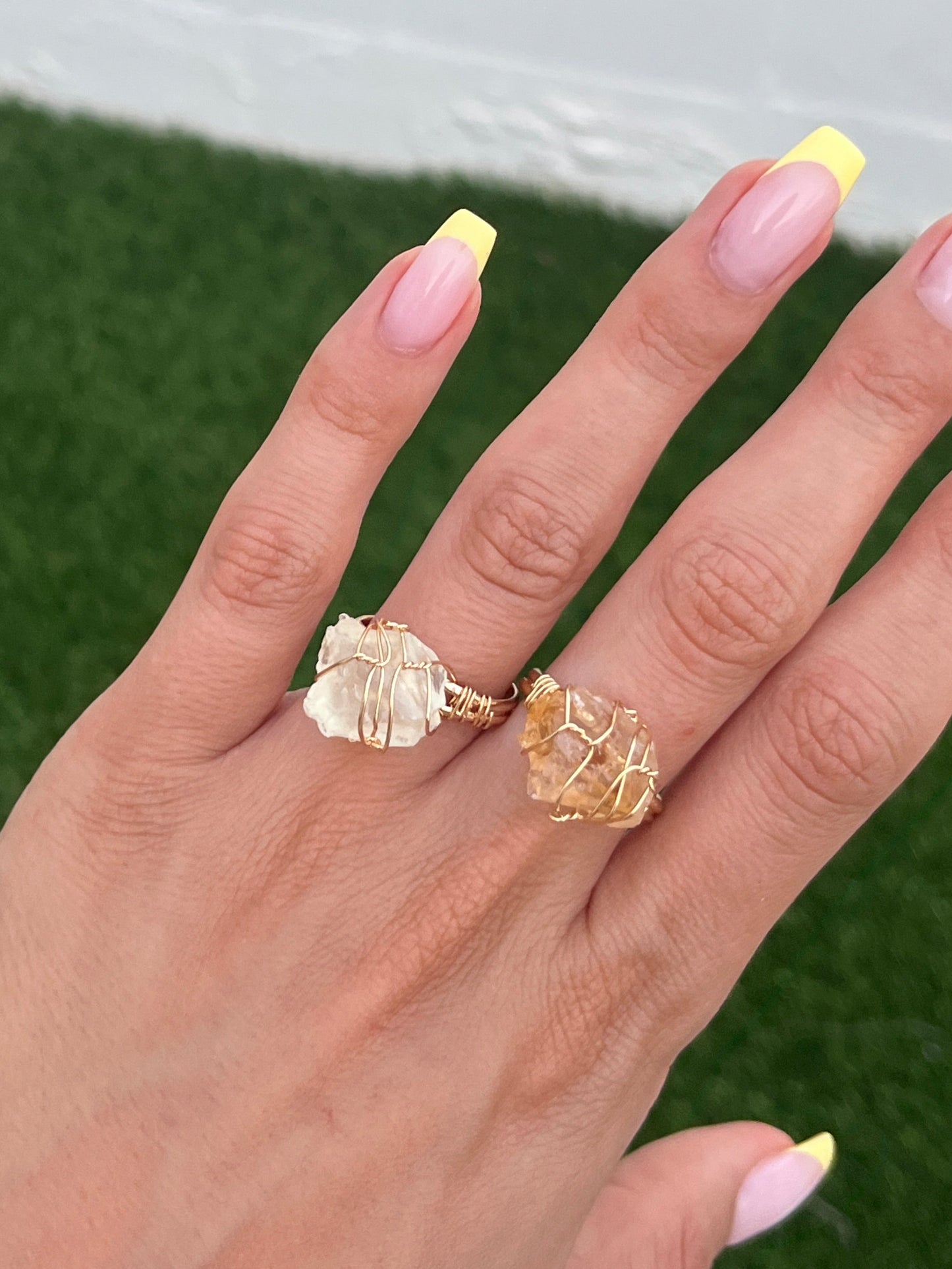 Miel Ring worn on hand with green backdrop