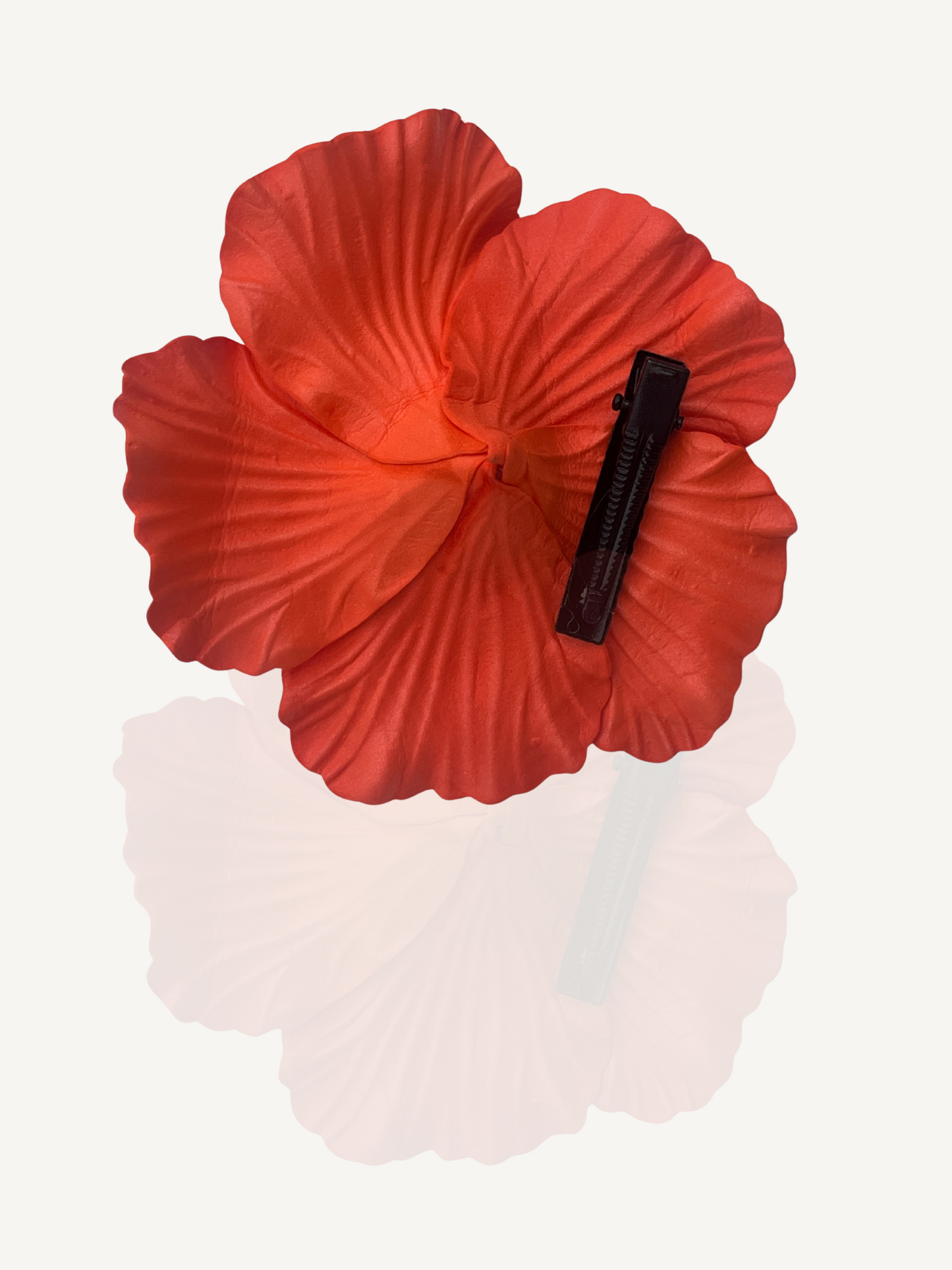 Woman wearing orange flower hair clip outdoors – Mediterranean vibe