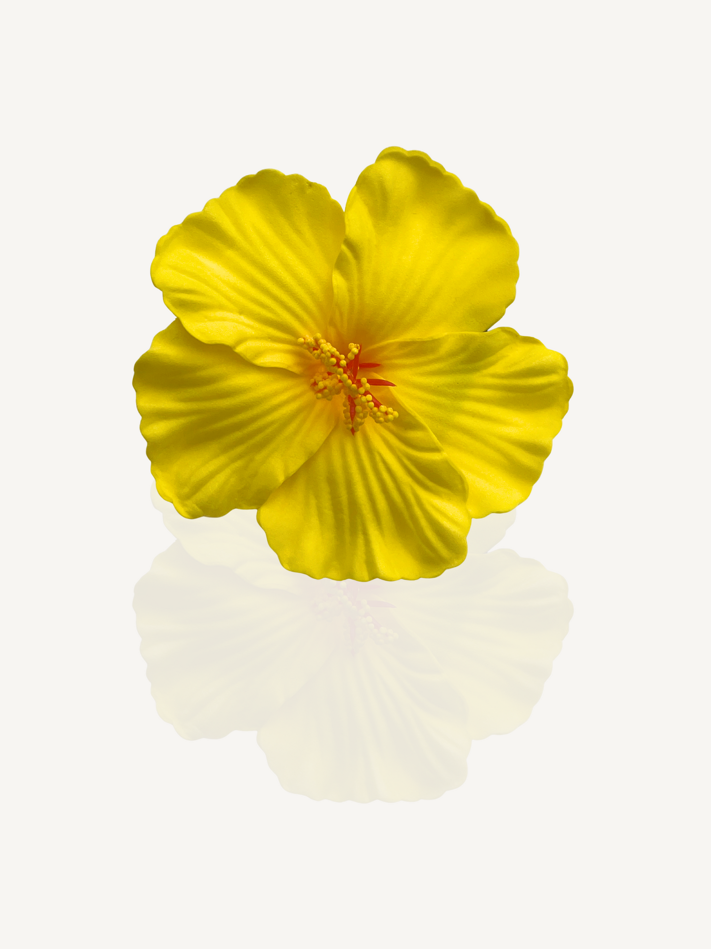 Flatlay of yellow flower hair clip – lightweight summer accessory