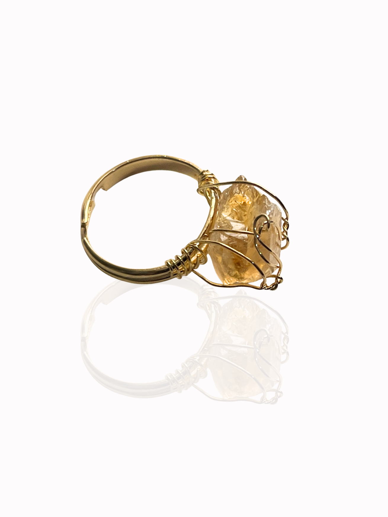 Honey stone ring on flatlay with gold base