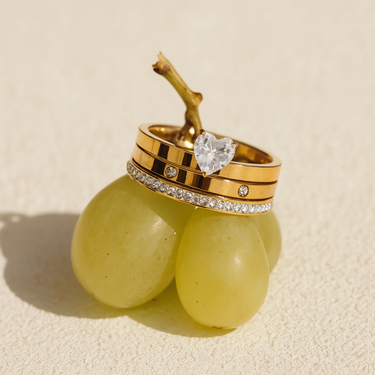 Gold-plated rings stacked on grapes – playful luxury summer jewelry

