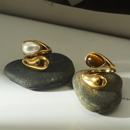 Minimalist shot of gold statement rings on neutral linen

