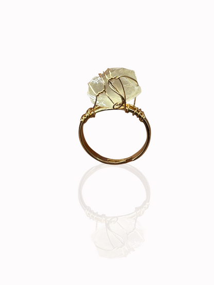 Sol Ring worn with other gold accessories on model hand

